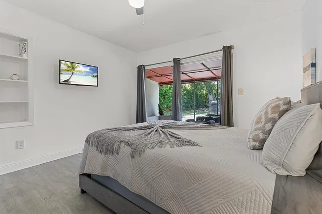 a bed sitting in a bedroom next to a window