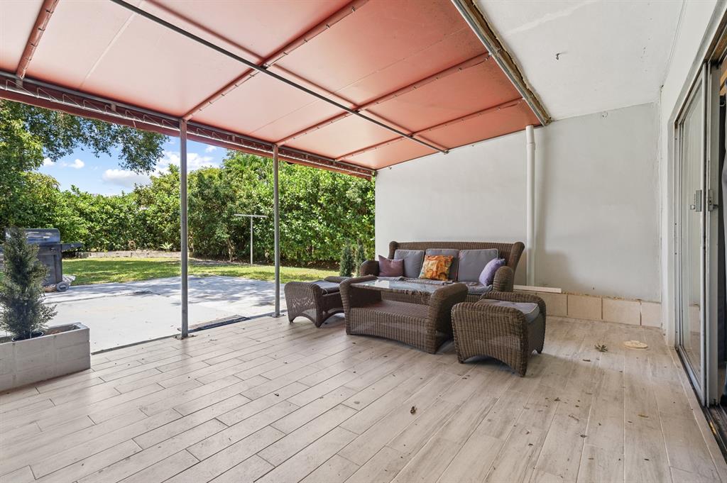 6375 Southwest 29th Street Miami, FL 33155 - Photo 26 of 51 a living room with furniture and a floor to ceiling window