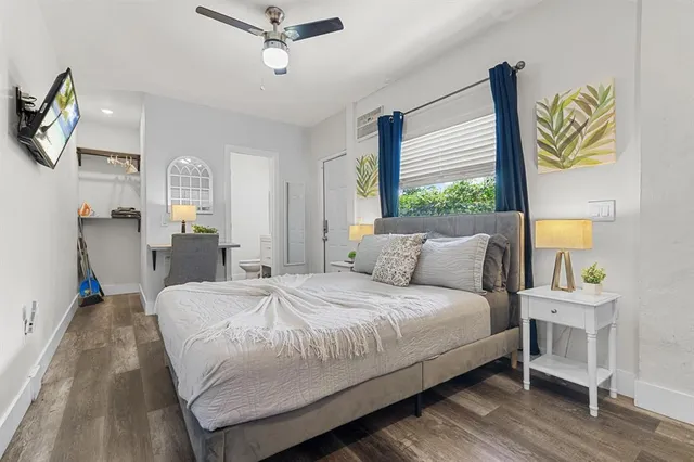 a bedroom with a bed table and a window