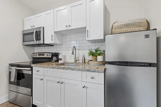 a white refrigerator freezer sitting inside of a kitchen
