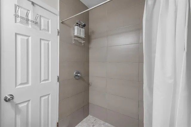 a bathroom with a glass shower door