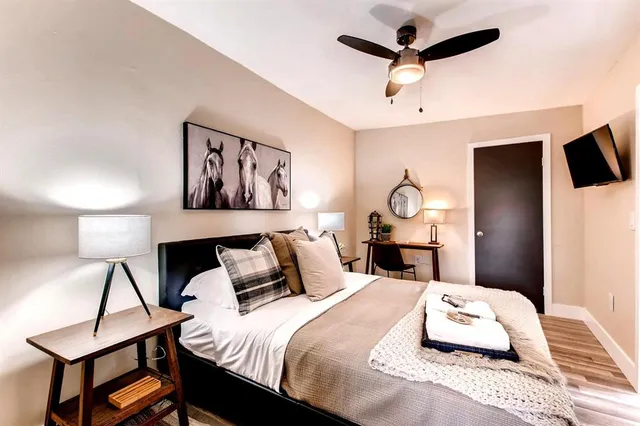 a bedroom with a bed mirror and window