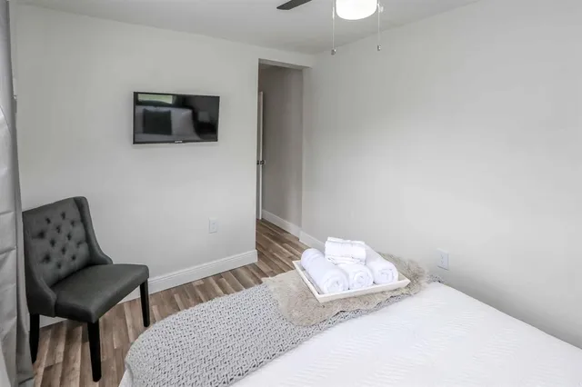 a bedroom with a bed and a flat screen tv