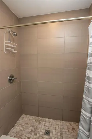 a bathroom with a sink a toilet and shower curtain