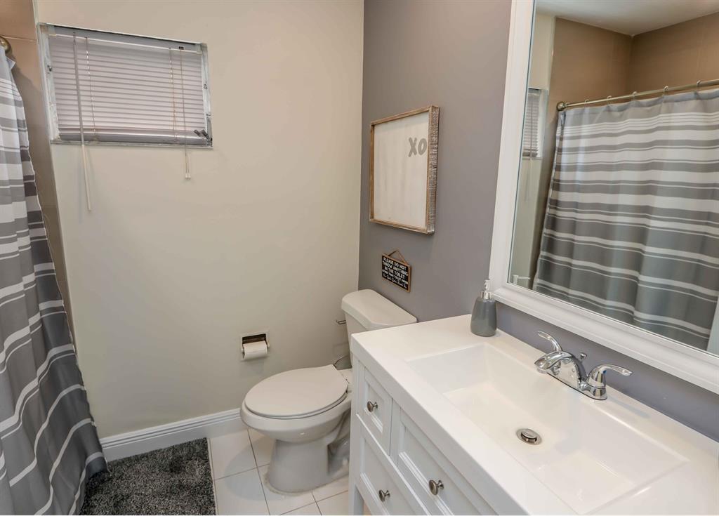 6375 Southwest 29th Street Miami, FL 33155 - Photo 48 of 51 a bathroom with a sink a toilet and shower curtain