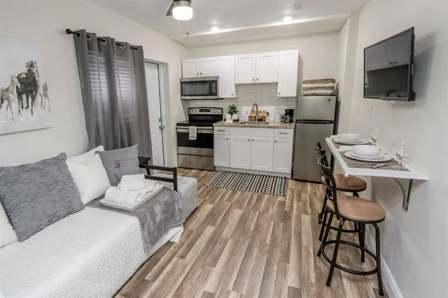 a living room with furniture and a flat screen tv