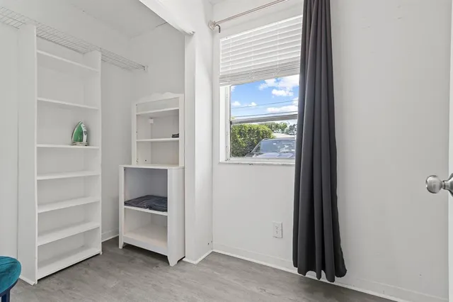 a view of a hallway with closet and cabinet