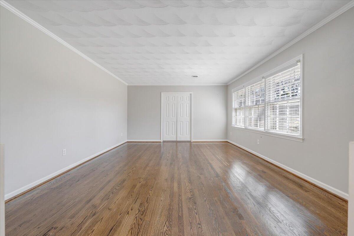 501 Darwin Road Southwest Roanoke, VA 24014 - Photo 12 of 37 an empty room with wooden floor and windows