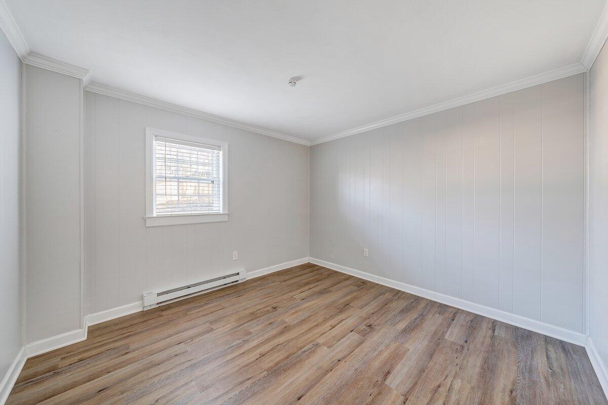 501 Darwin Road Southwest Roanoke, VA 24014 - Photo 32 of 37 an empty room with wooden floor and windows