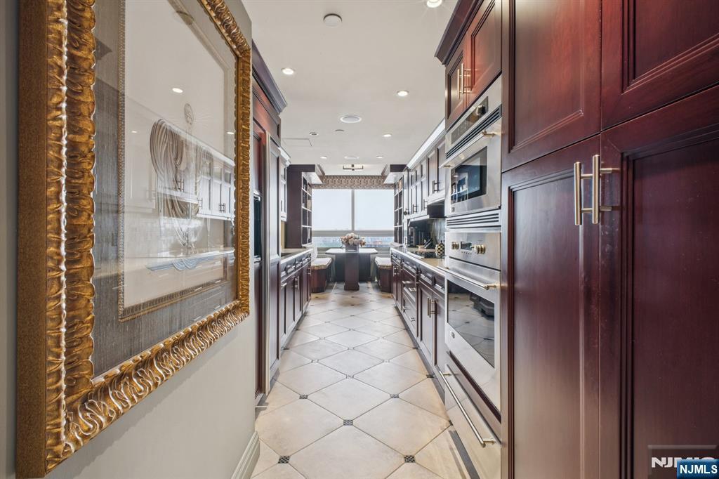 800 Palisade Avenue, Unit PH21A Fort Lee, NJ 07024 - Photo 12 of 50 a kitchen with stainless steel appliances granite countertop a refrigerator and a stove