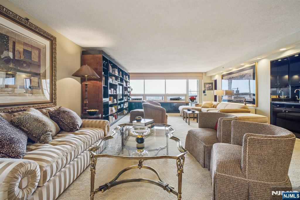 800 Palisade Avenue, Unit PH21A Fort Lee, NJ 07024 - Photo 3 of 50 a living room with furniture kitchen view and a large window