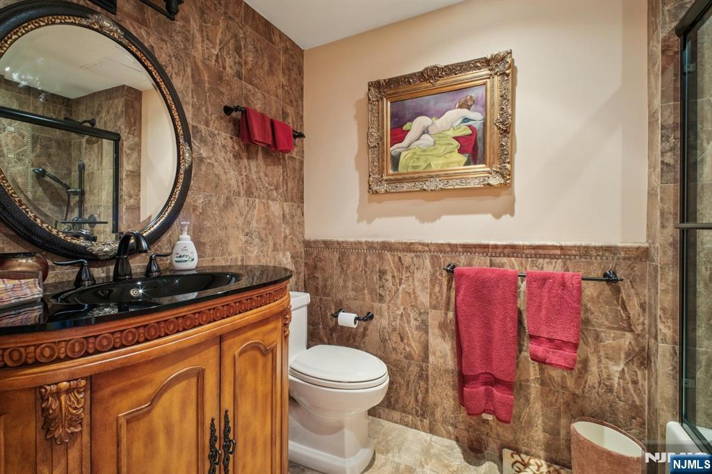 800 Palisade Avenue, Unit PH21A Fort Lee, NJ 07024 - Photo 32 of 50 a bathroom with a toilet a sink and a mirror