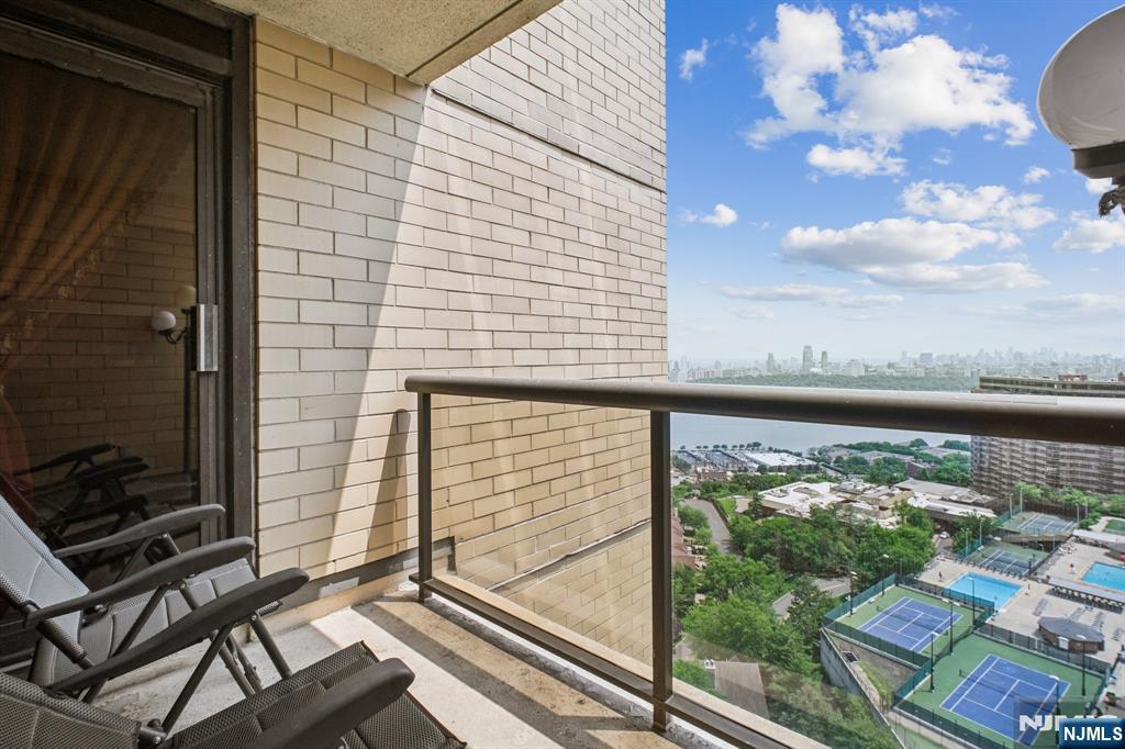 800 Palisade Avenue, Unit PH21A Fort Lee, NJ 07024 - Photo 37 of 50 a view of a balcony with wooden floor and a bench