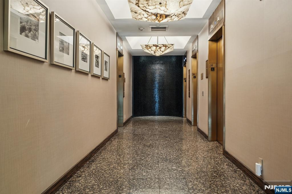 800 Palisade Avenue, Unit PH21A Fort Lee, NJ 07024 - Photo 41 of 50 a view of a hallway with a dining table