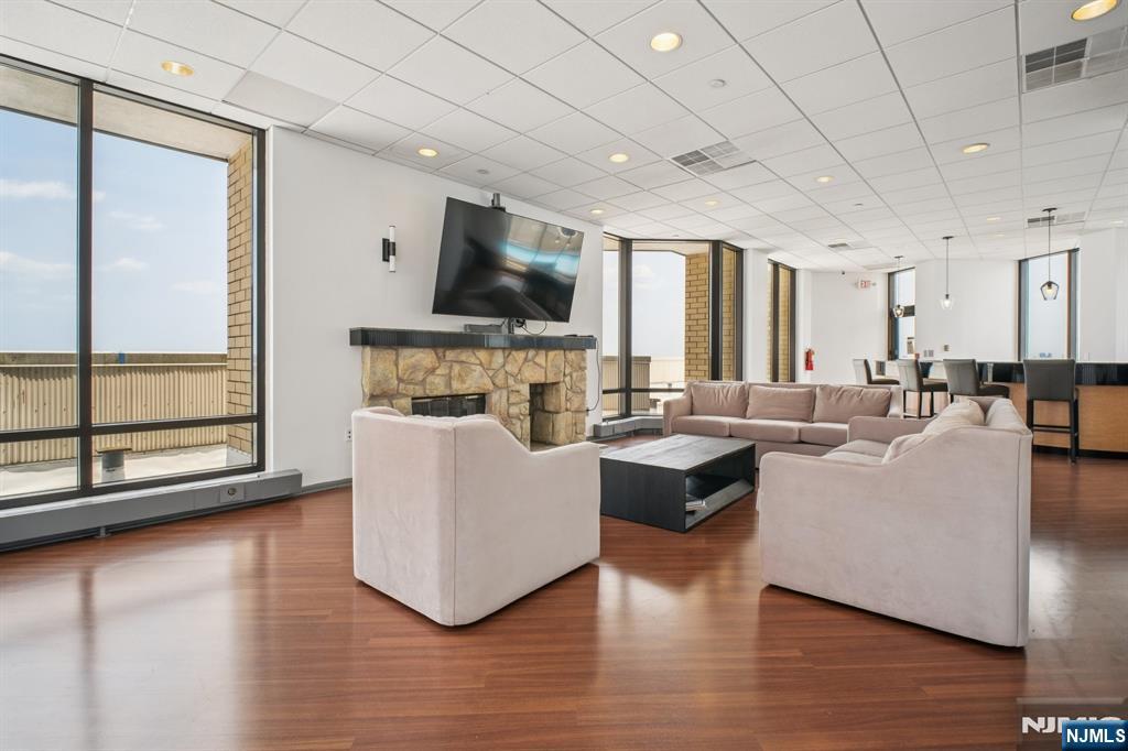 800 Palisade Avenue, Unit PH21A Fort Lee, NJ 07024 - Photo 44 of 50 a living room with furniture wooden floor and a flat screen tv