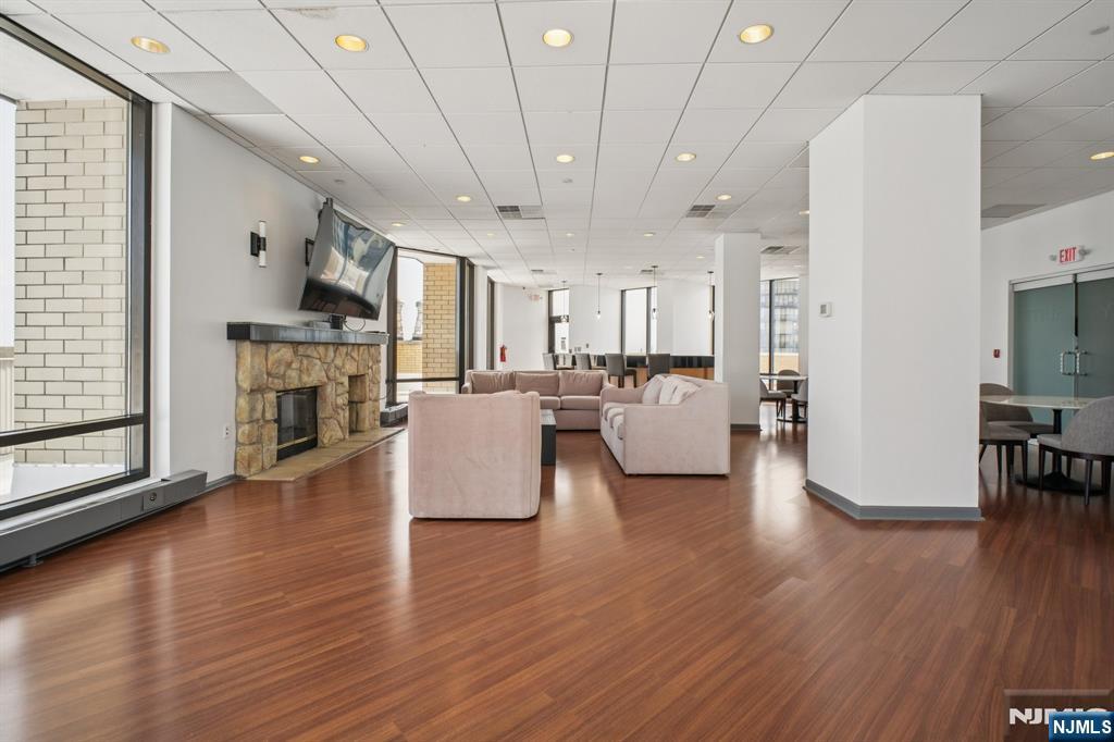 800 Palisade Avenue, Unit PH21A Fort Lee, NJ 07024 - Photo 45 of 50 a living room with furniture wooden floor and a fireplace