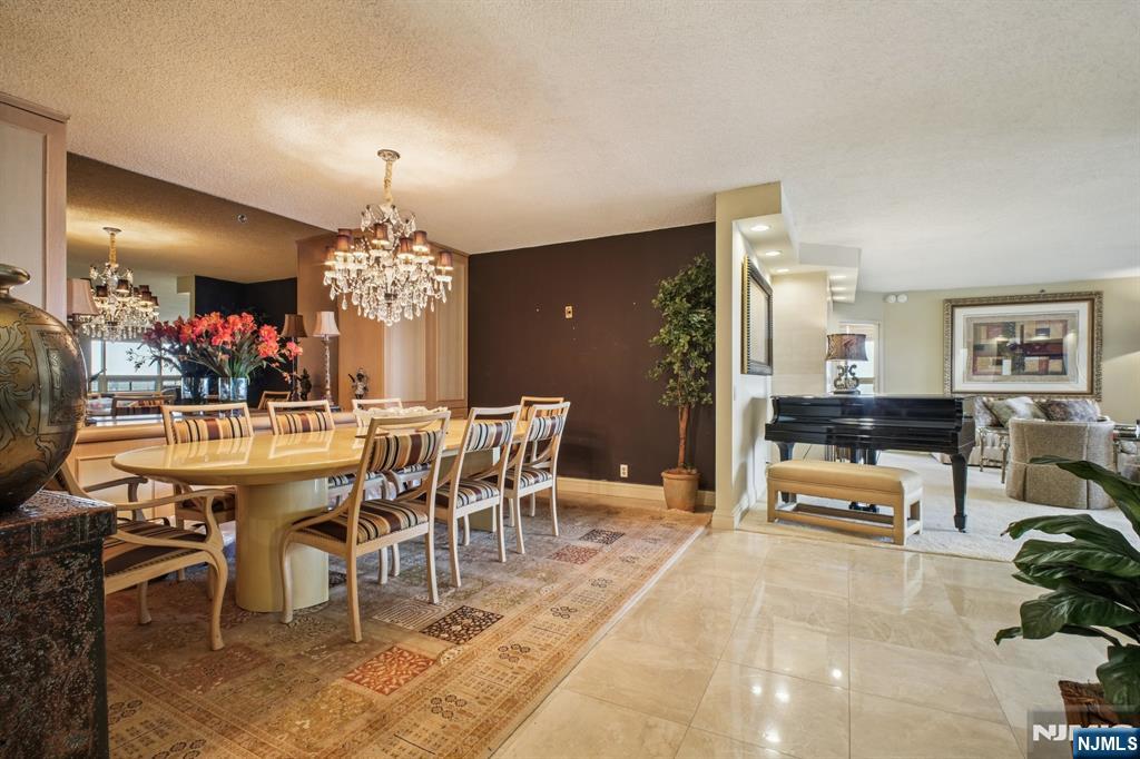 800 Palisade Avenue, Unit PH21A Fort Lee, NJ 07024 - Photo 9 of 50 a view of a dining room with furniture and chandelier