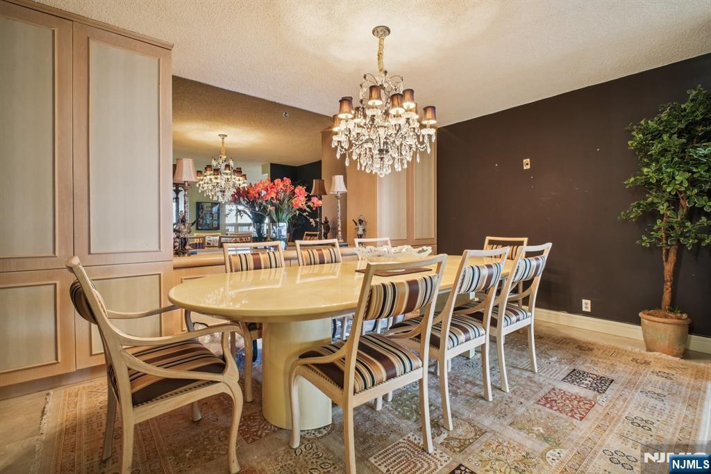800 Palisade Avenue, Unit PH21A Fort Lee, NJ 07024 - Photo 10 of 50 a view of a dining room with furniture and chandelier
