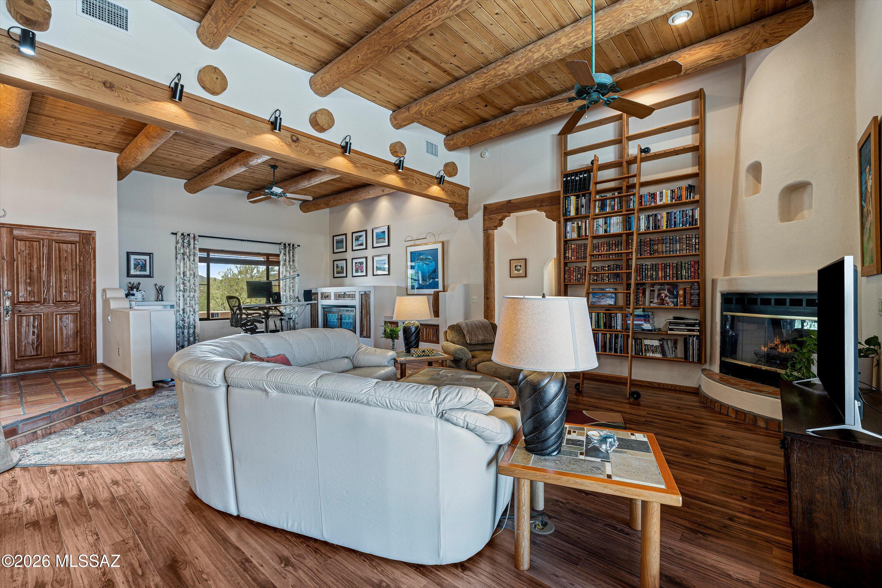 11160 East Golf Links Road Tucson, AZ 85730 - Photo 10 of 51 The high ceilings along with the built in bookshelf elevate your sight to the warm wood accents.