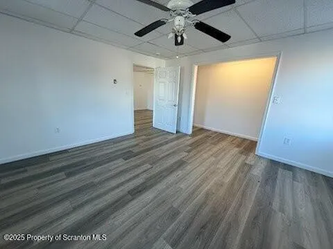 an empty room with wooden floor and closet