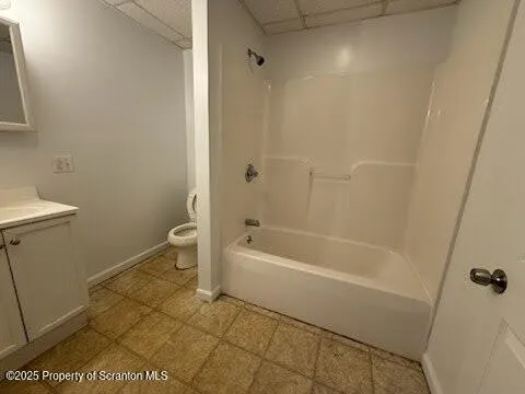 a bathroom with a bathtub a toilet and a shower