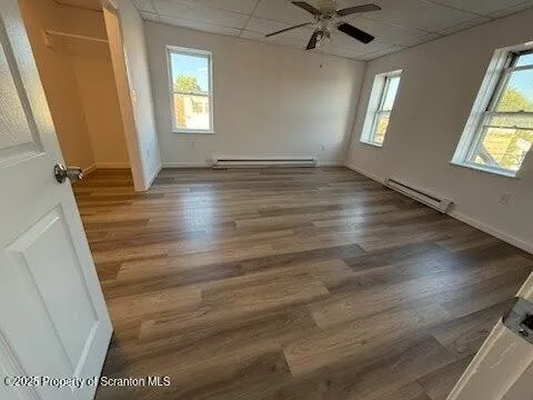wooden floor in an empty room with a window