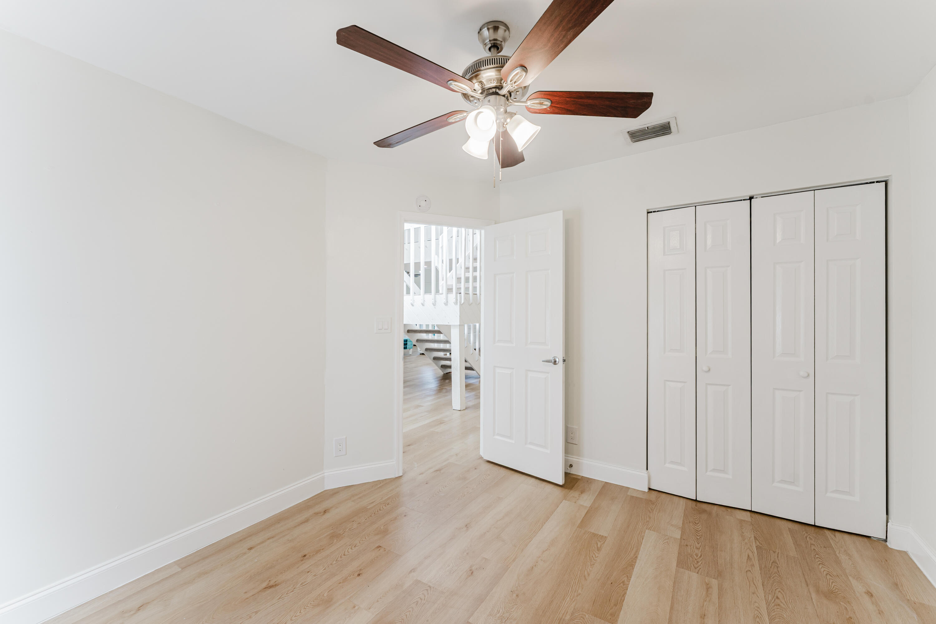 665 Jeffery Street Boca Raton, FL 33487 - Photo 5 of 44 an empty room with wooden floor fan and windows