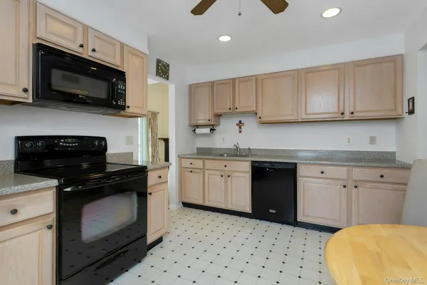 a kitchen with a sink stove and microwave
