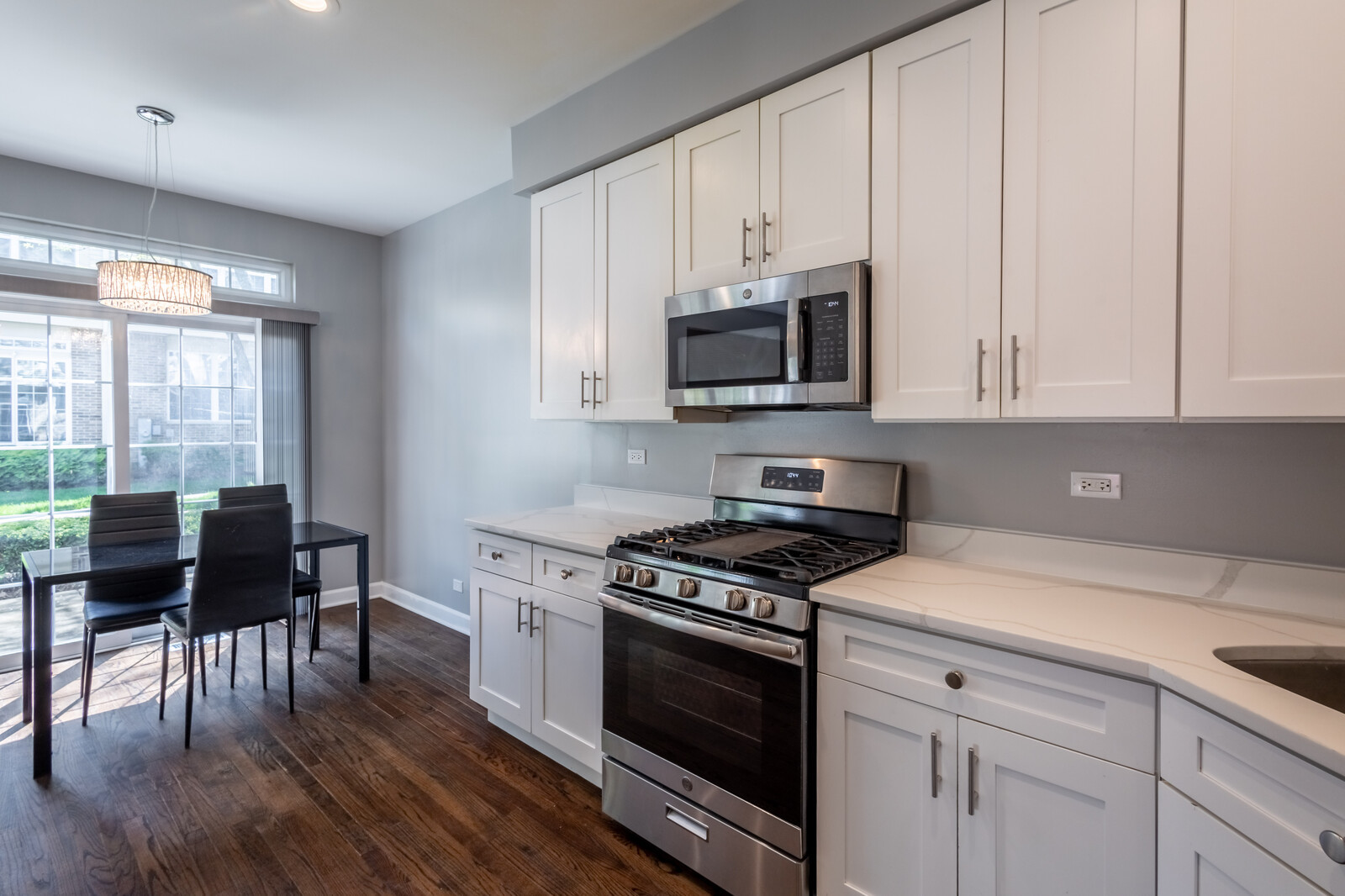 1244 Georgetown Way Vernon Hills, IL 60061 - Photo 7 of 17 a kitchen with granite countertop a stove a sink dishwasher a microwave oven with a dining table and chairs