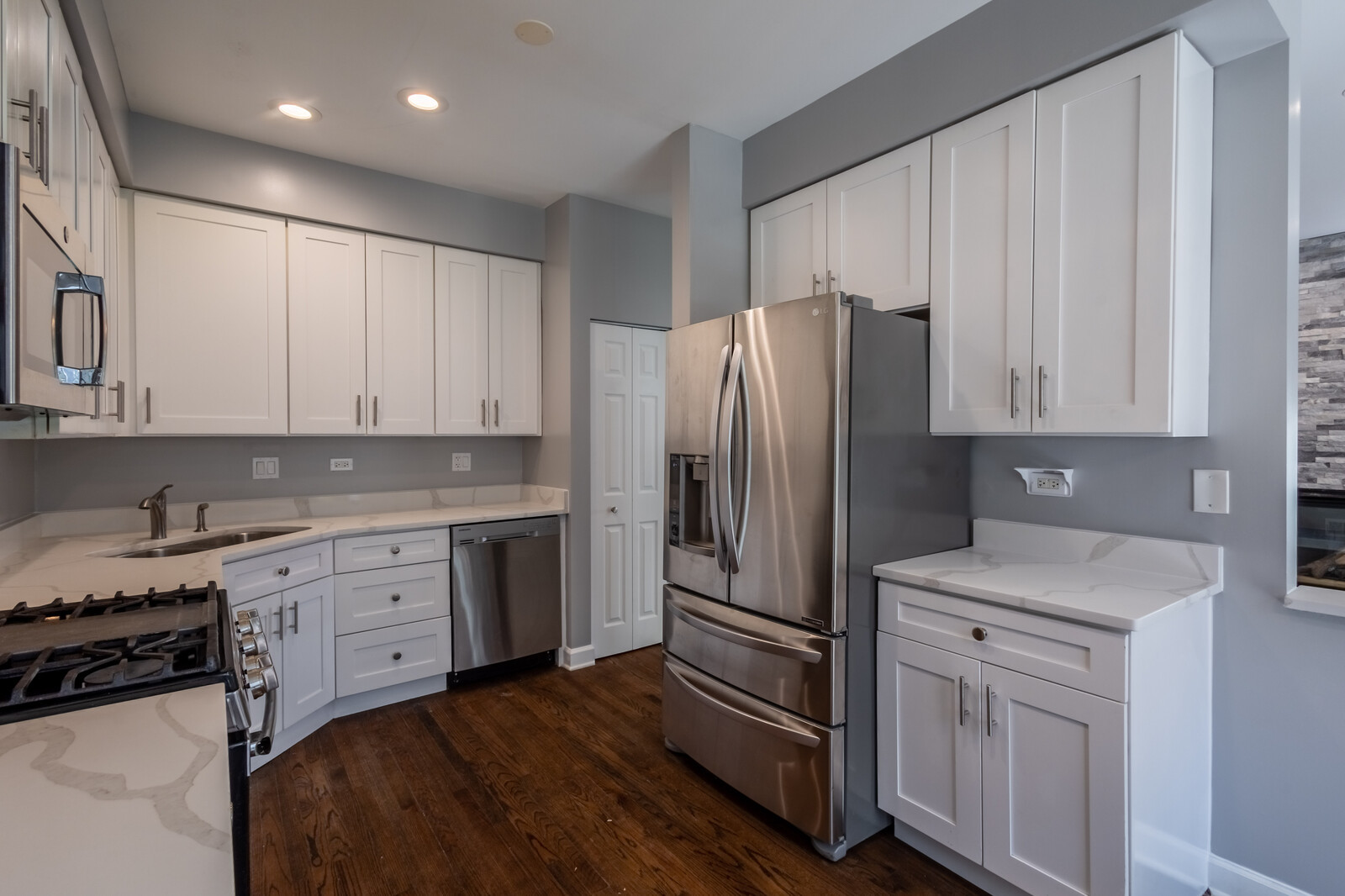 1244 Georgetown Way Vernon Hills, IL 60061 - Photo 8 of 17 a kitchen with white cabinets and stainless steel appliances