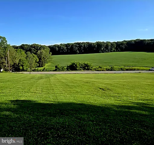 a view of a golf course with a ocean view