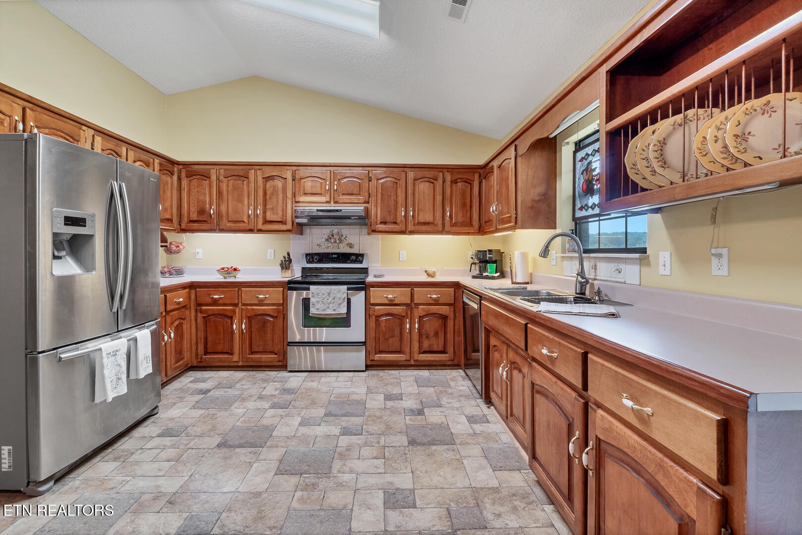 449 Foss Road Maryville, TN 37801 - Photo 19 of 49 a large kitchen with stainless steel appliances granite countertop a stove a sink dishwasher a refrigerator and cabinets with wooden floor