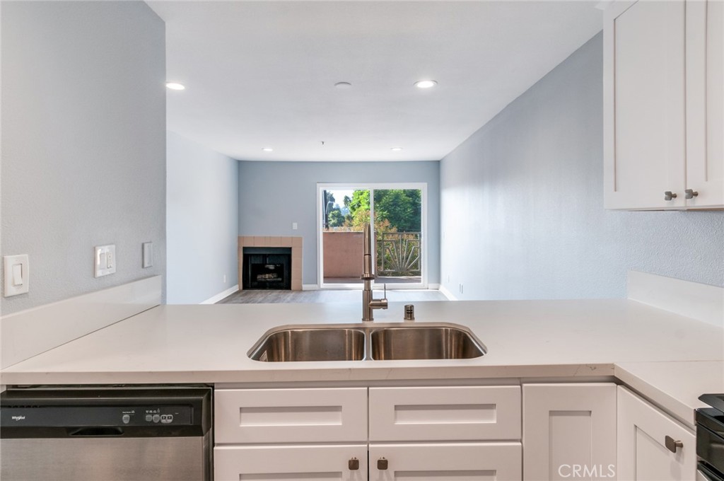 450 East 4th Street, Unit 221 Santa Ana, CA 92701 - Photo 16 of 43 a kitchen with a sink and a refrigerator