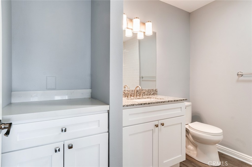 450 East 4th Street, Unit 221 Santa Ana, CA 92701 - Photo 19 of 43 a bathroom with a toilet sink and mirror