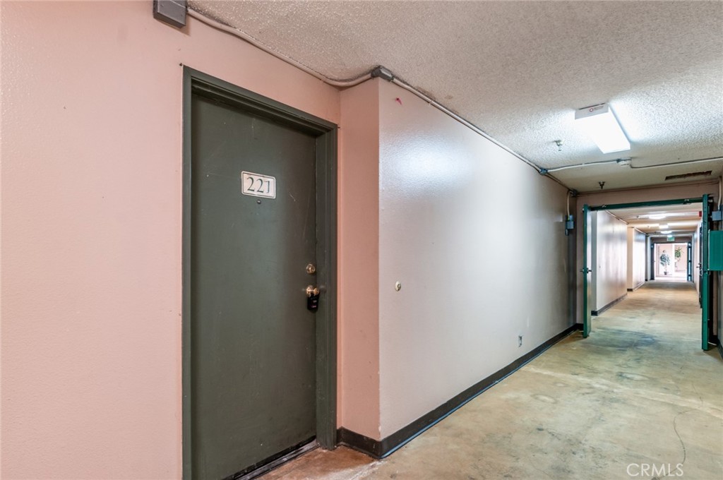450 East 4th Street, Unit 221 Santa Ana, CA 92701 - Photo 22 of 43 a view of a hallway with wooden shelves