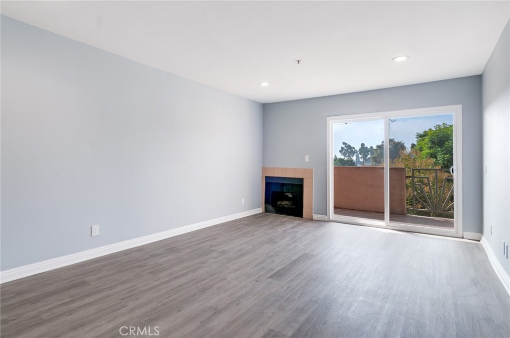 450 East 4th Street, Unit 221 Santa Ana, CA 92701 - Photo 10 of 43 a view of an empty room with wooden floor and a window