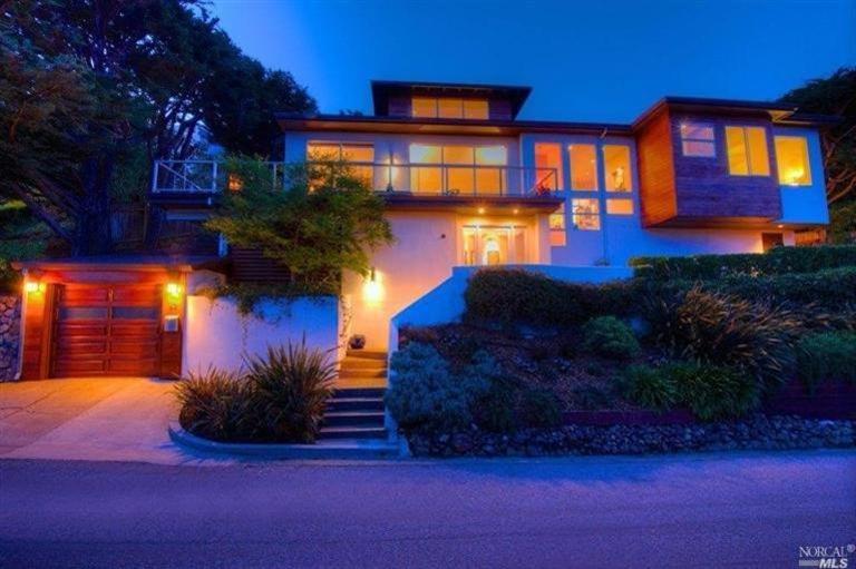 a front view of a house with a yard and outdoor seating