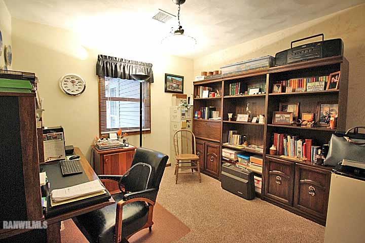 8130 East River Road Ridott, IL 61067 - Photo 12 of 25 a room with furniture a bookshelf and a window