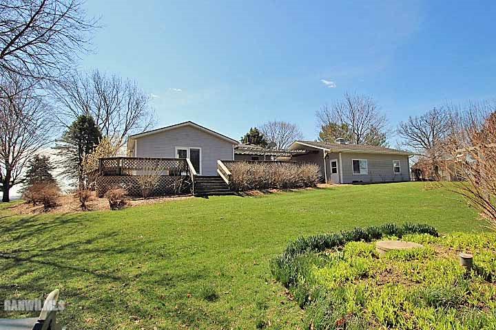 8130 East River Road Ridott, IL 61067 - Photo 4 of 25 a front view of house with a garden