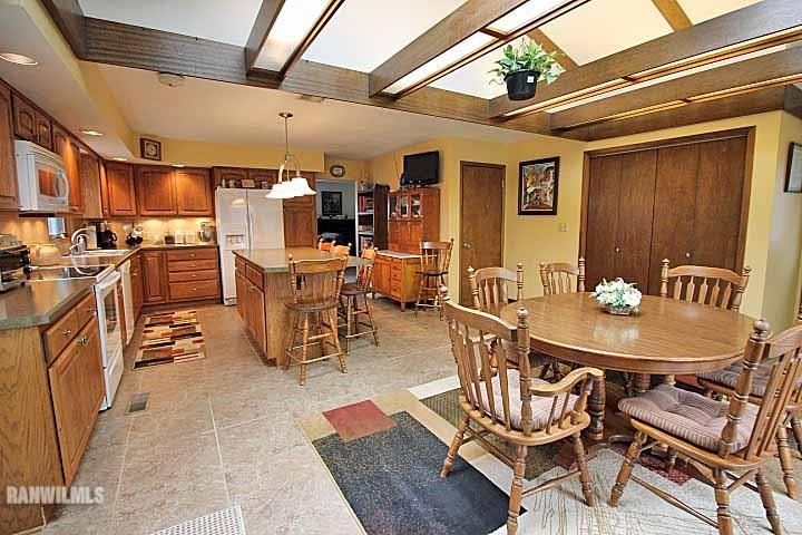 8130 East River Road Ridott, IL 61067 - Photo 6 of 25 a view of a dining room with furniture and chandelier
