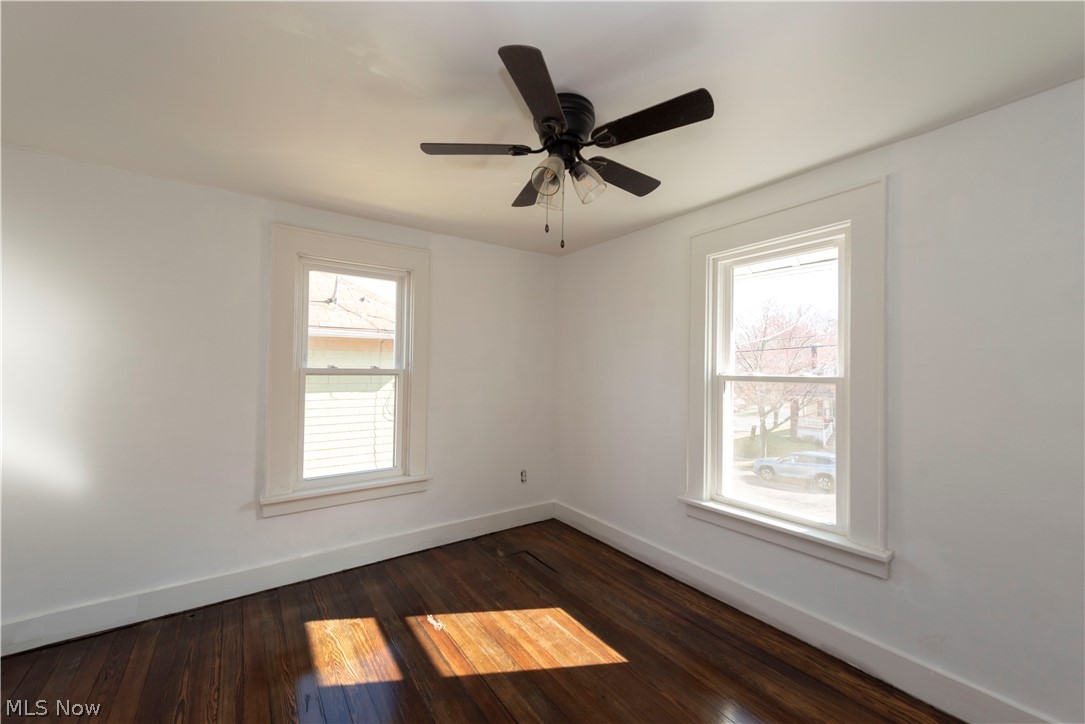 1022 North Howard Street Akron, OH 44310 - Photo 20 of 38 Bedroom 3 featuring dark hardwood floors, ceiling fan, and a healthy amount of sunlight