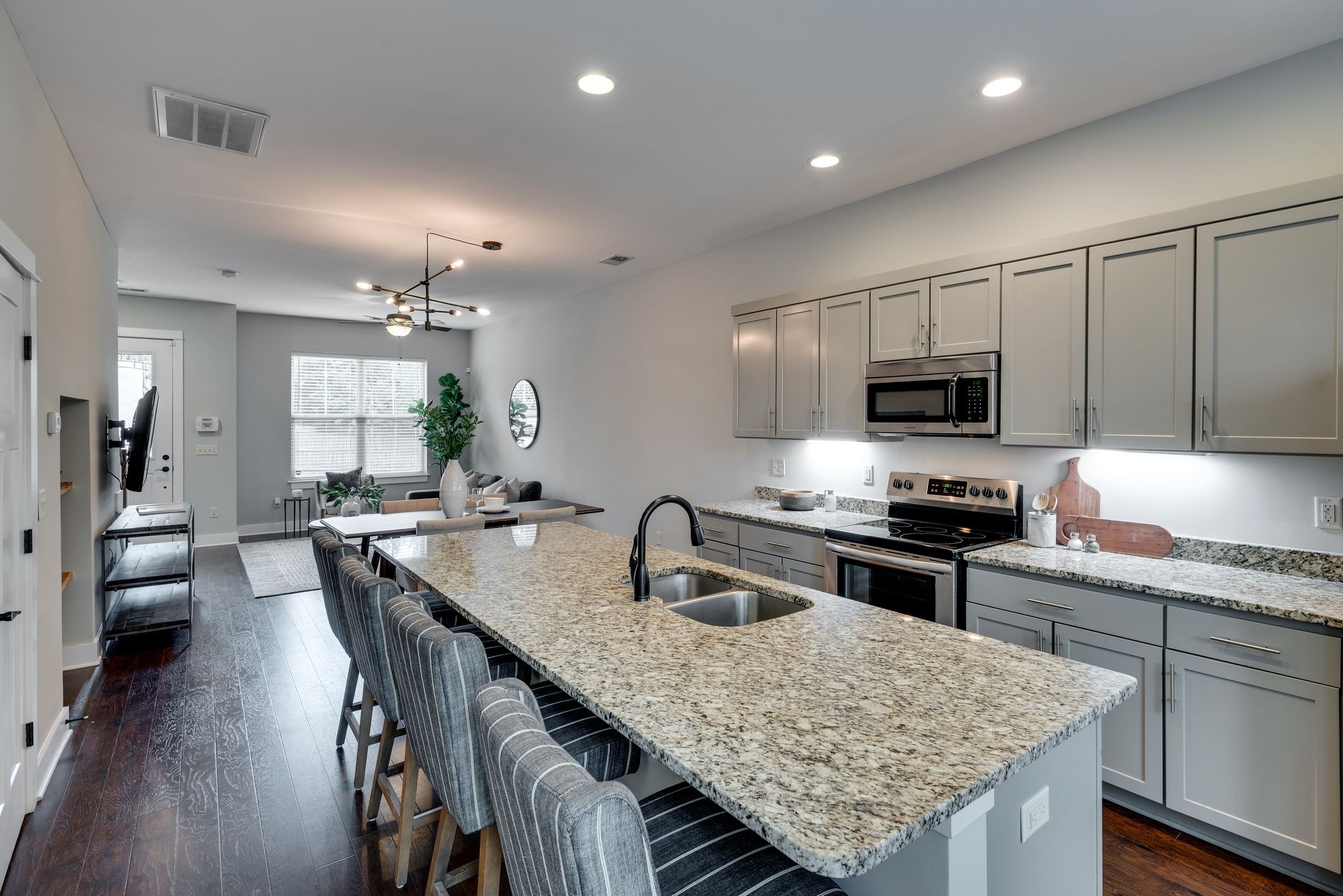 1106 Stratford Avenue, Unit 3 Nashville, TN 37216 - Photo 10 of 23 a kitchen with granite countertop kitchen island sink stove and white cabinets