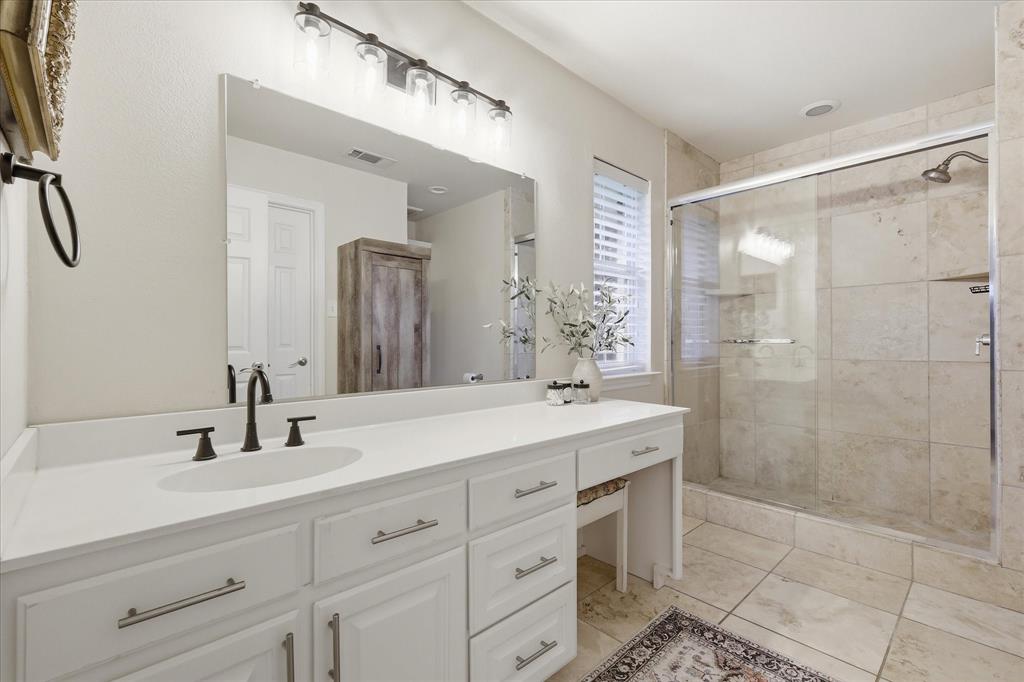 202 Colonial Heights Sanger, TX 76266 - Photo 16 of 27 a bathroom with a double vanity sink mirror and shower