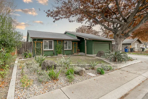 a front view of a house with garden