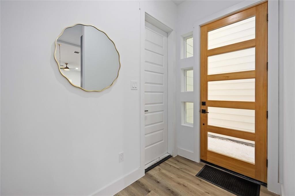 1805 Emir Street, Unit L Houston, TX 77009 - Photo 4 of 35 The entry way includes a modern door with glass inserts that allow plenty of light into the home. The door to the left leads to a two car garage.