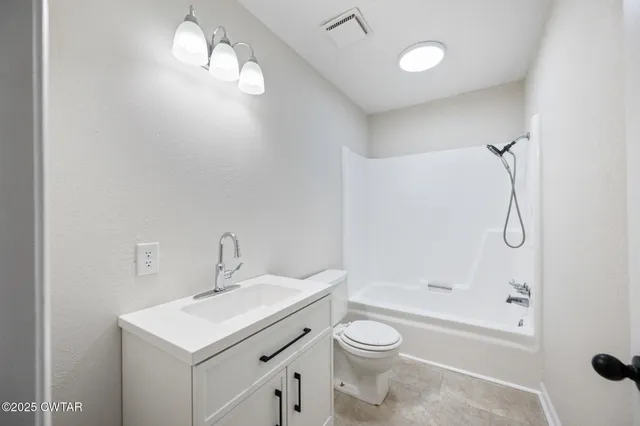 a bathroom with a sink toilet a shower and a mirror
