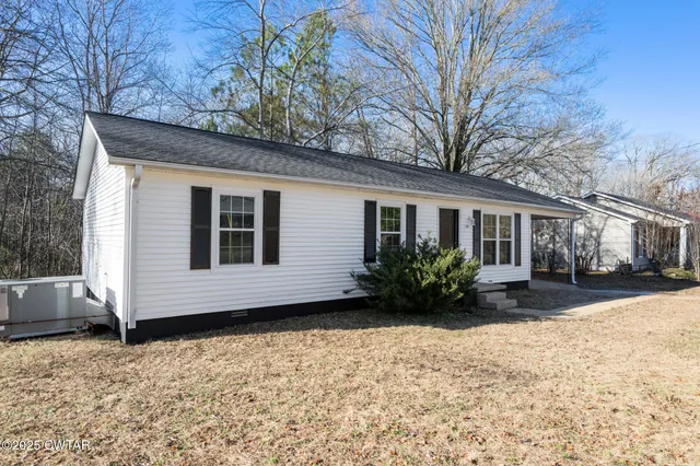 a view of a house with a yard covered in snow