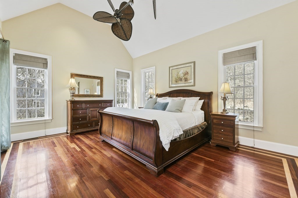 19 Whippoorwill Lane Concord, MA 01742 - Photo 18 of 33 a bedroom with a bed and wooden floor