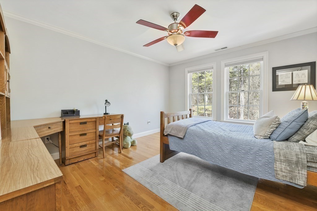 19 Whippoorwill Lane Concord, MA 01742 - Photo 21 of 33 a bedroom with a bed and wooden floor