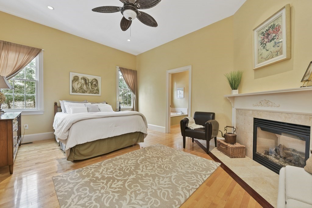 19 Whippoorwill Lane Concord, MA 01742 - Photo 23 of 33 a bedroom with a bed and a fireplace